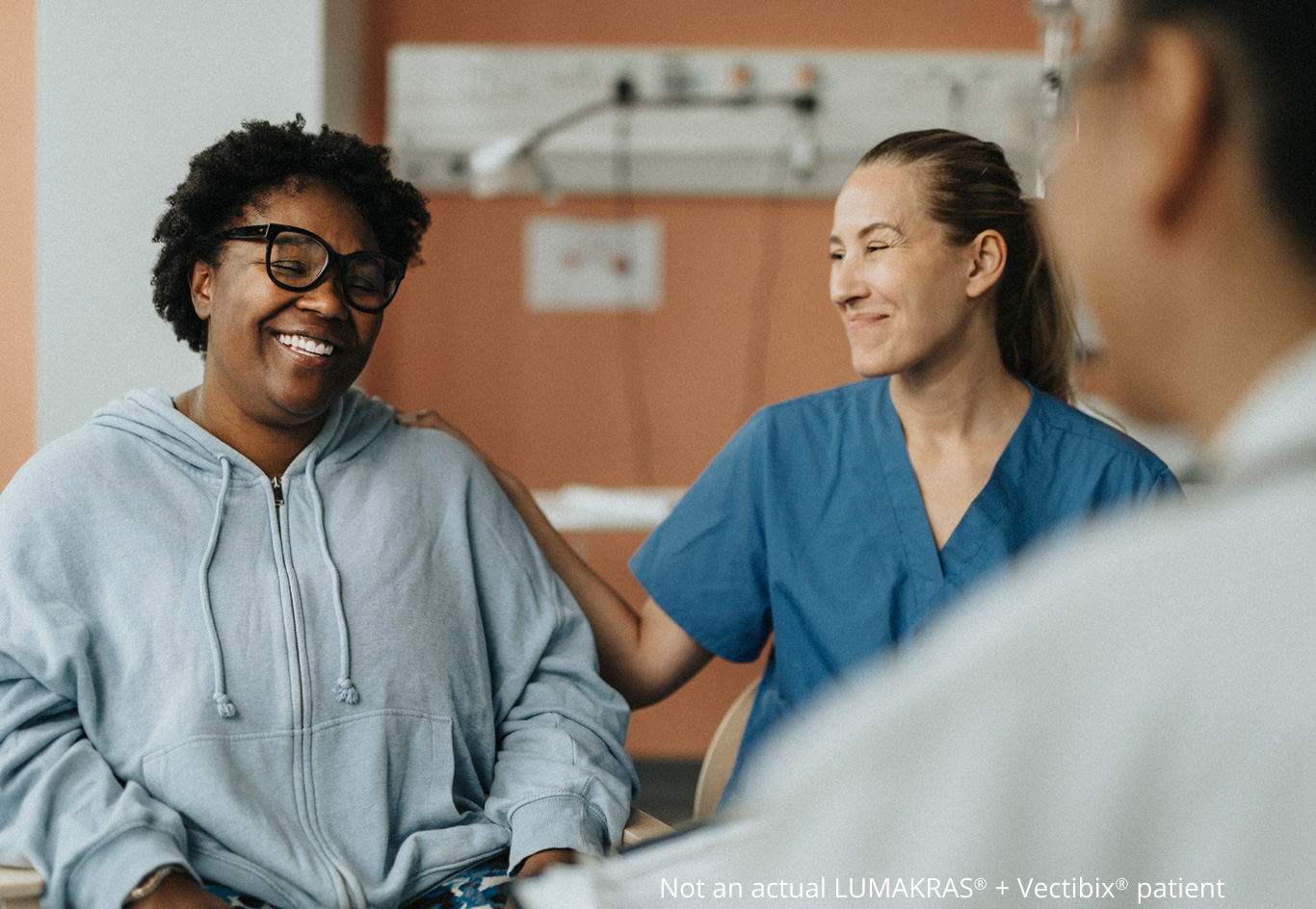 Patient laughing with a nurse and doctor