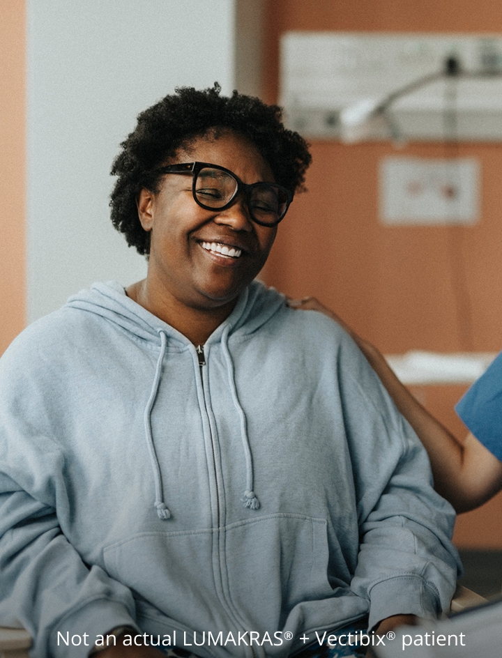Patient laughing with a nurse and doctor